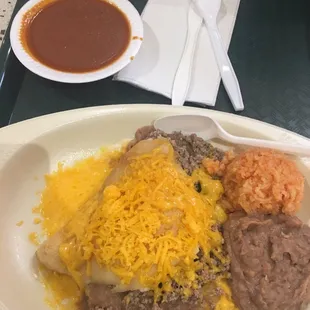 a plate of enchiladas and beans