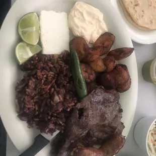 Churrasco salvadoreño. Steak rice and beans,fried plantains, queso fresco and sour cream. Great dish.