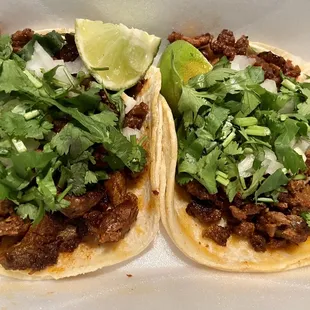 two tacos on a white plate