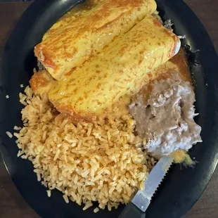 #1 - Two burritos with rice and beans.