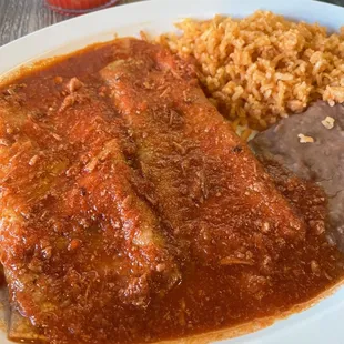 Lunch cheese enchiladas with beans and rice