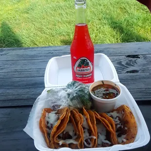 Birria tacos with beans a la charra, consommé and Jarritos fruit punch.