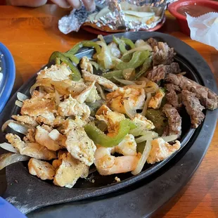 Fajitas with chicken, beef, and shrimp
