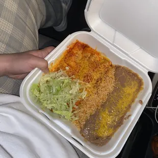 a person holding a styrofoam container