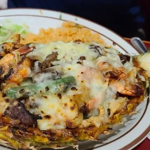 Grilled pineapple with fajita steak,  chicken and shrimp