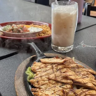Chicken Fajitas with rice and beans and all the traditional fixings and a delicious horchata to drink.