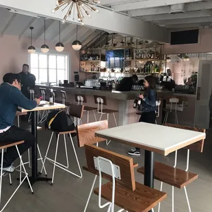 people sitting at tables in a restaurant