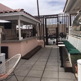 a patio with a grill and a table