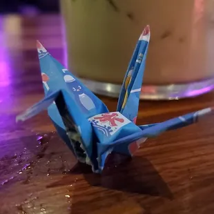 a paper crane on a table
