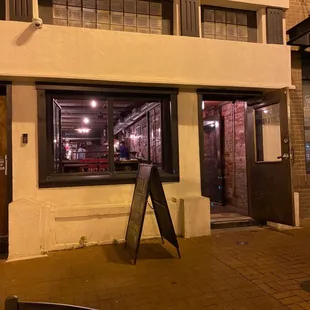 an empty sidewalk in front of a building
