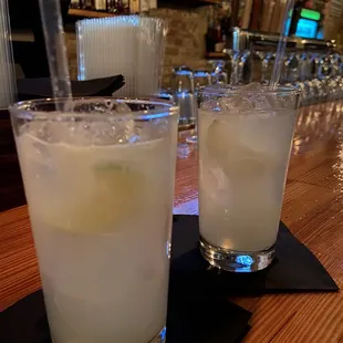 two glasses of lemonade on a bar