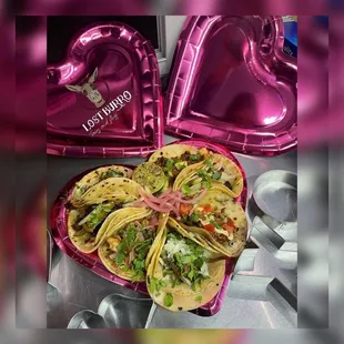 a heart shaped tray of tacos