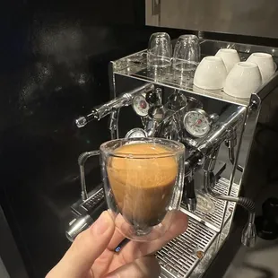 a person holding a cup of coffee