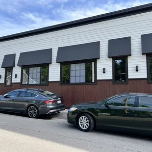 two cars parked in front of a restaurant
