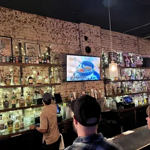 people watching tv in a bar