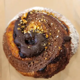 a chocolate donut with sprinkles on top