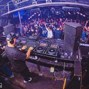 a dj in front of a crowd of people