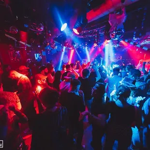 a crowd of people dancing at a nightclub