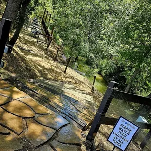 a muddy path with a sign on it