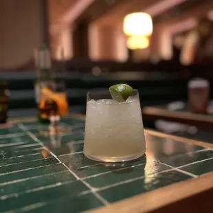 a margarita with a lime garnish