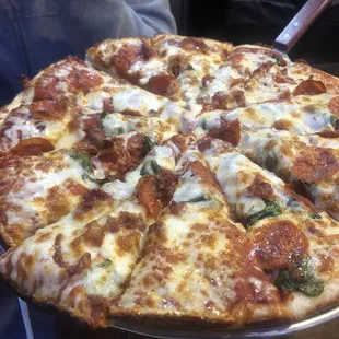 Spinach, pepperoni, and bacon pizza