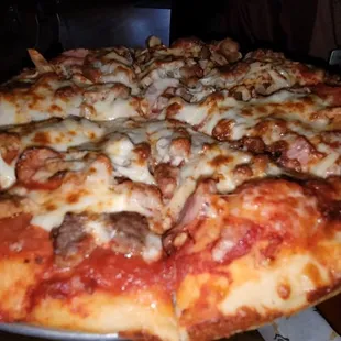 a pizza with meat and cheese