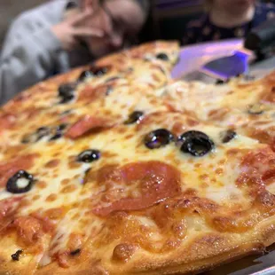 a pizza with pepperoni and olives