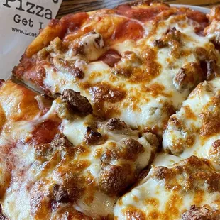 Individual pizza with thick crust and sausage