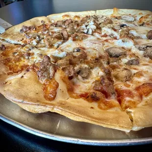 Thin pizza with sausage and mushrooms