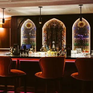 a bar with orange chairs