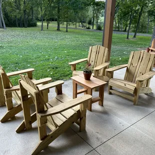 wooden chairs and a table on a patio