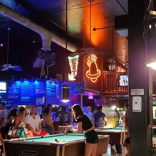 people playing pool in a bar