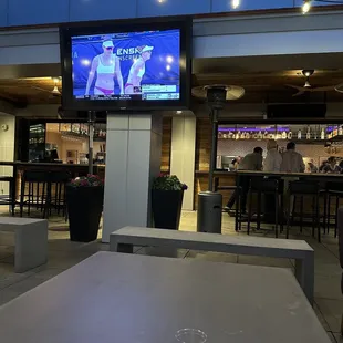 a television screen and tables