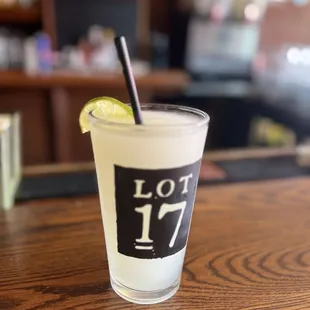 a shot of a drink with a lime slice on the rim