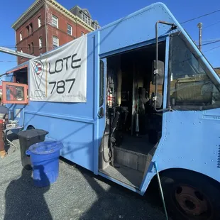 a blue food truck parked in a parking lot