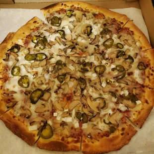 Pizza with mushrooms, onions and jalapeños