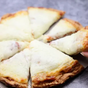 a person holding a slice of pizza