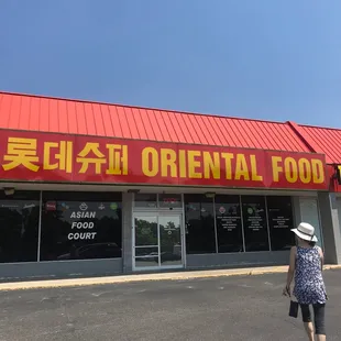 a woman walking in front of the store