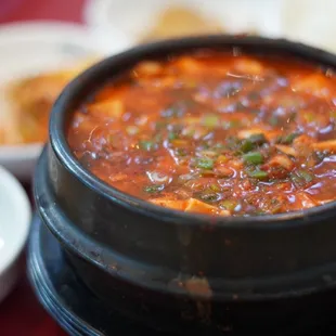 a bowl of soup and bowls of rice