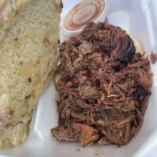 a pulled pork sandwich with a side of coleslaw