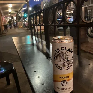 a can of beer on a bench