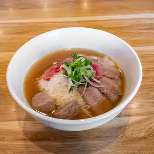 a bowl of soup on a wooden table