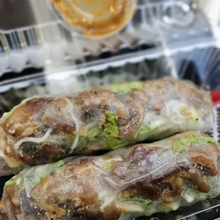 two rolls of food in a plastic container