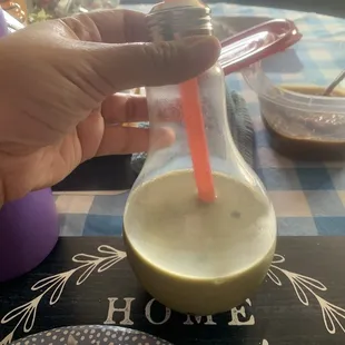 Half gone green tea boba in the bulb cup