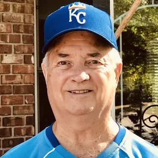 a man in a blue baseball uniform