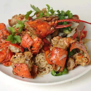 a plate of lobster and noodles