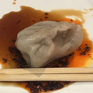 Yummy steamed dumplings... one shown with hot sauce and dumpling sauce