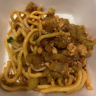 a plate of noodles with meat and vegetables