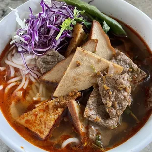 Vegetarian Spicy Noodle Soup to go. Great quality tofu slices and tasty broth! Close flavors to the spicy beef noodle soup!