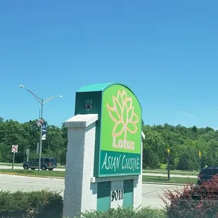 a sign in front of a parking lot
